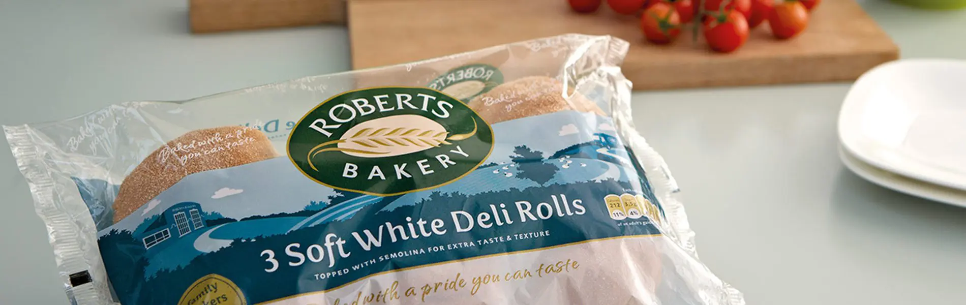 A package of Roberts Bakery White Bread Rolls is displayed.