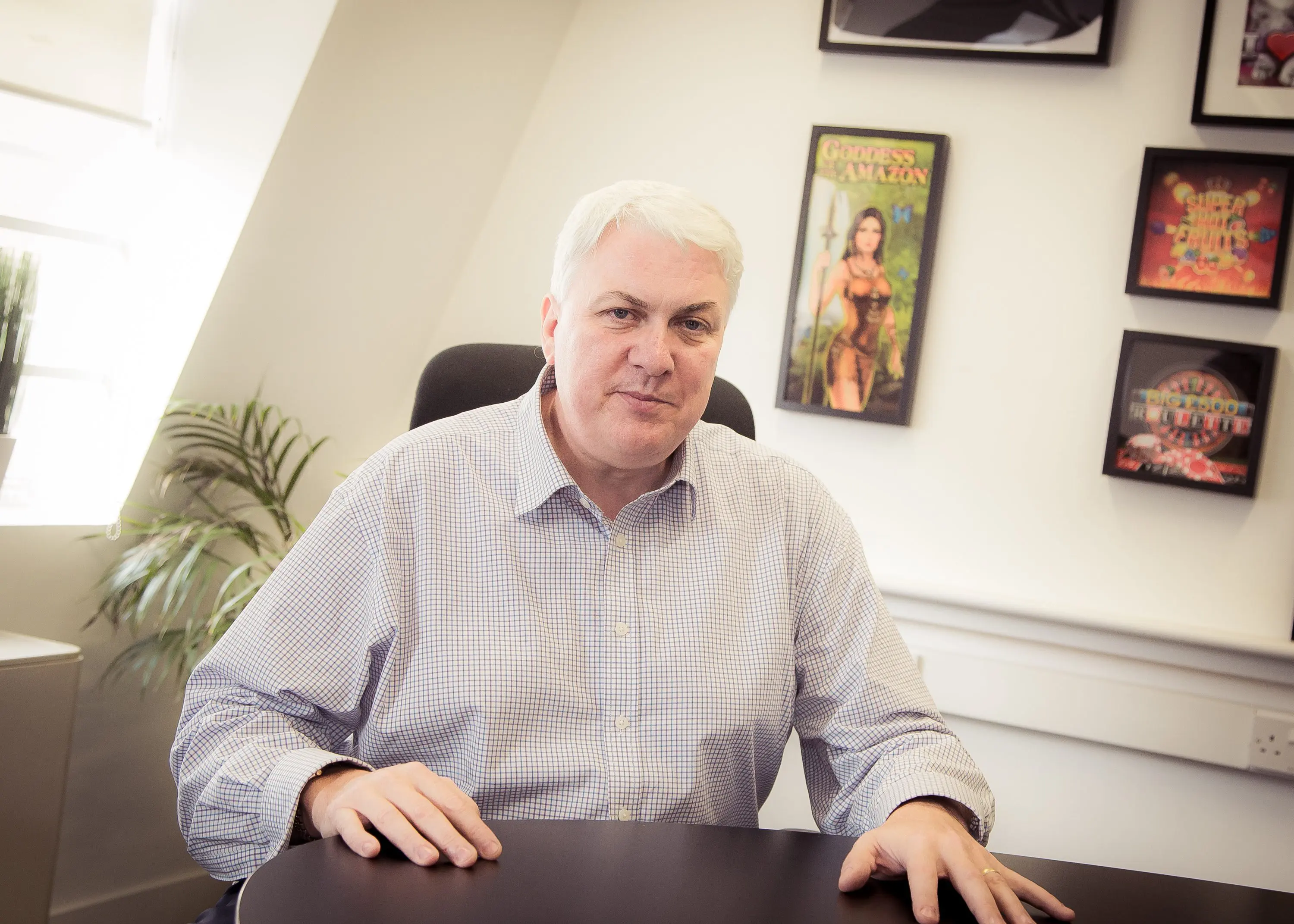 Alex MacGregor-Devlin, seated at a desk.