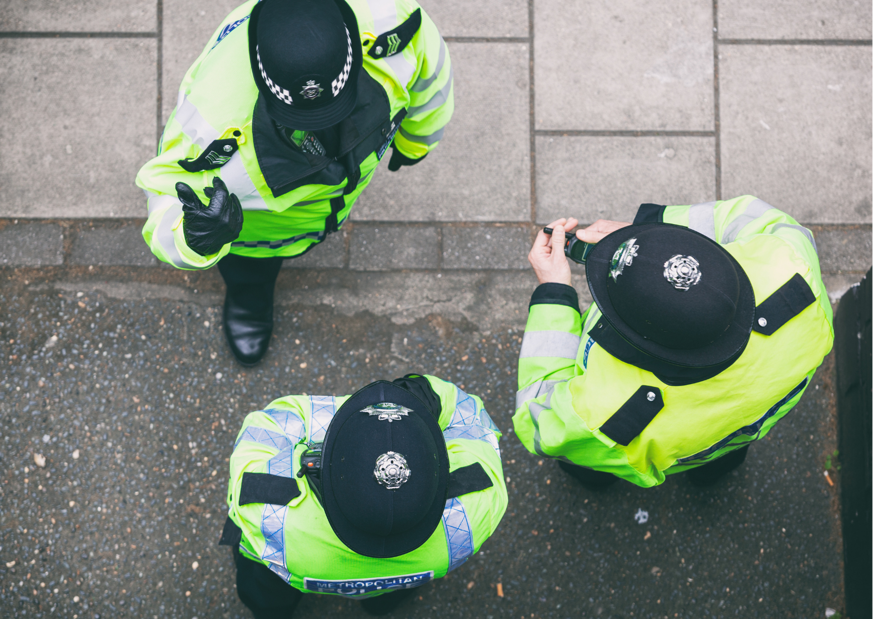 3 police officers stood, talking to each other