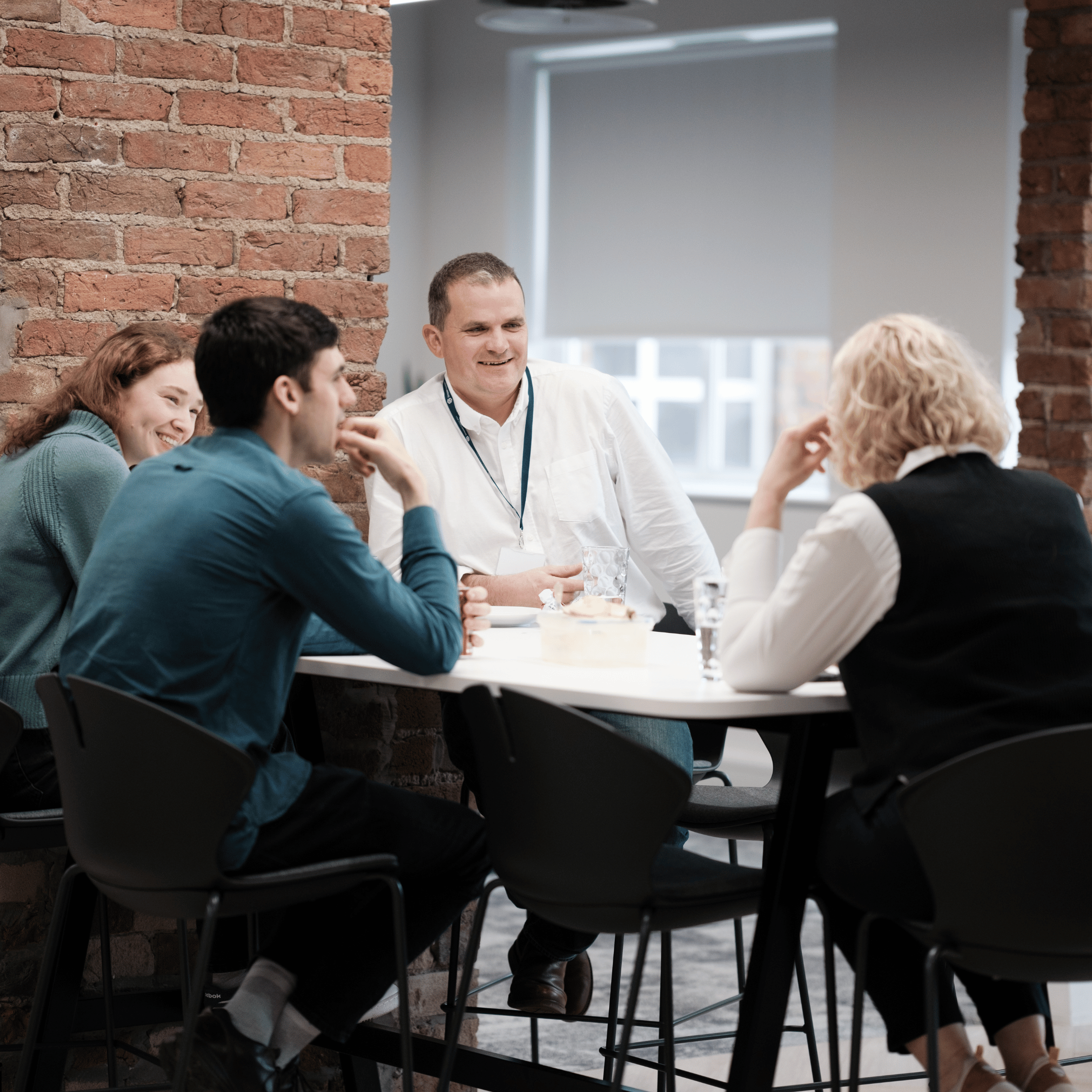 Simpson Associates team seated around a table in discussion.